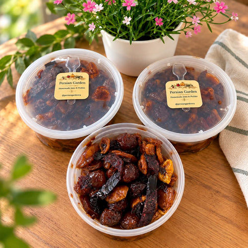 Three tubs of Persian Garden homemade aloocheh, one open, on a wooden table